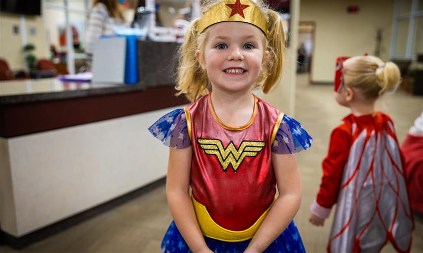 Children in costume trick or treat around school
